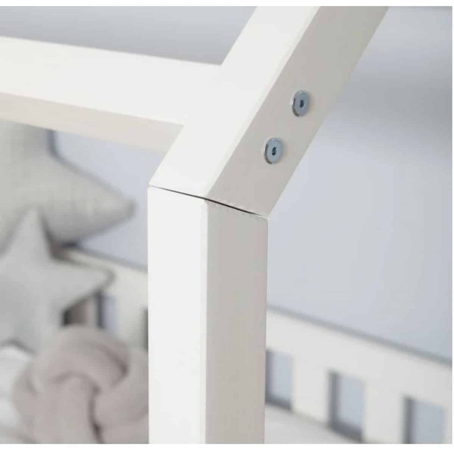 Close-up of a white crib with a blurred background